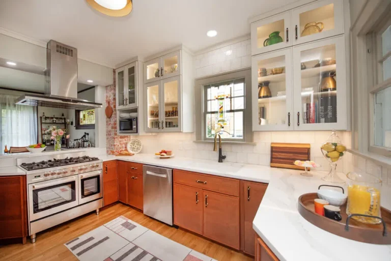 Modern farmhouse kitchen with hidden pantry and telescoping faucet.